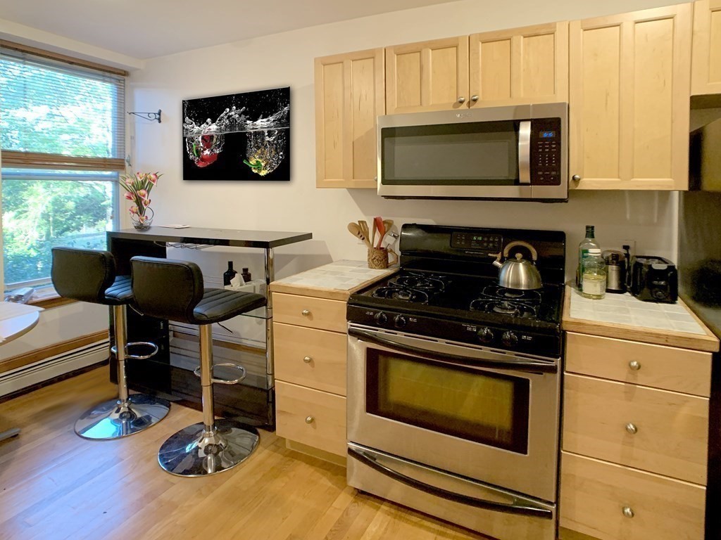 148 Berkshire Street, Unit 4 Cambridge, MA 02141 - Photo 10 of 17 a kitchen with a stove and a microwave