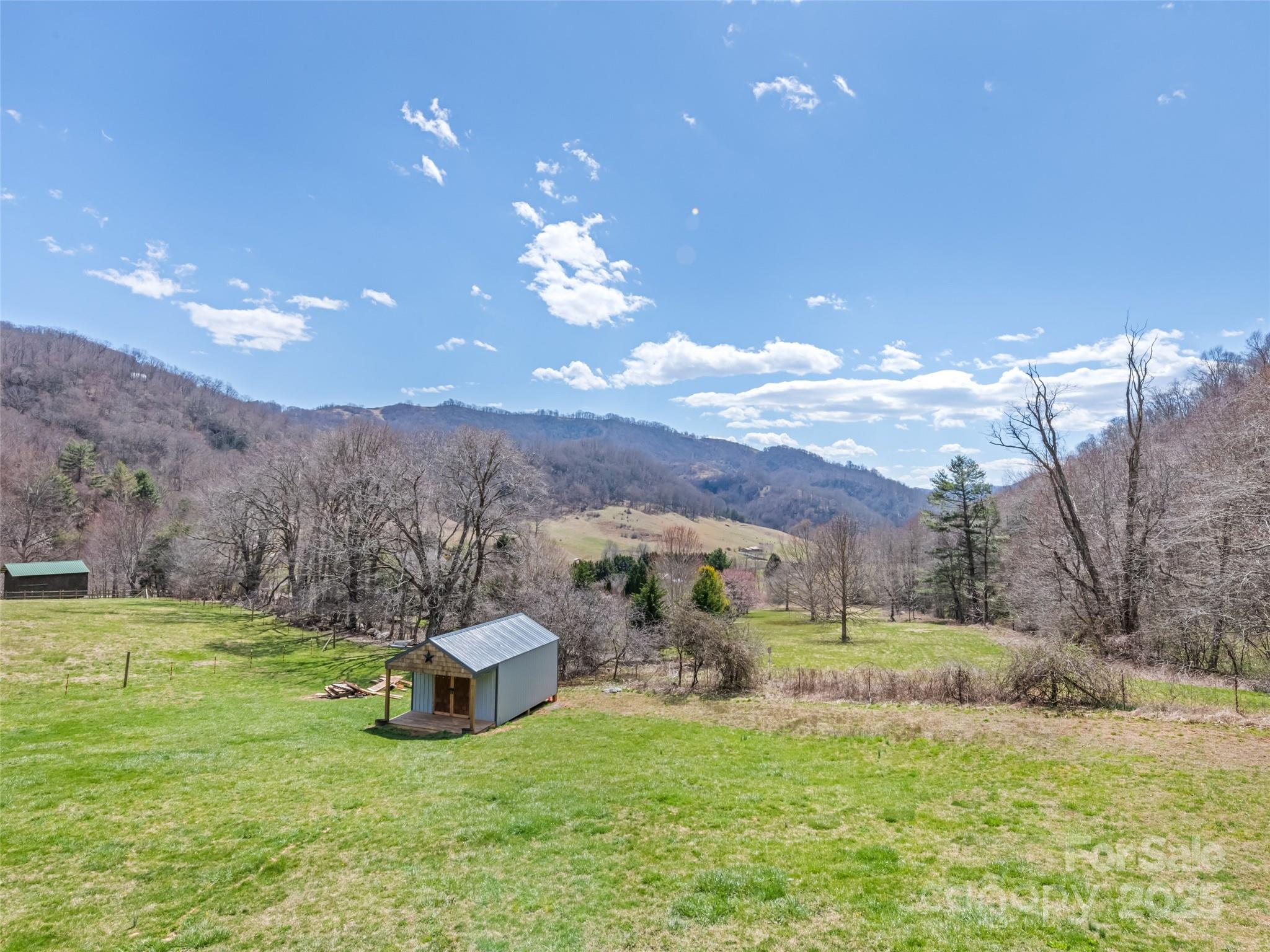 153 Trinity Drive Clyde, NC 28721 - Photo 14 of 38 a view of a big house with a big yard