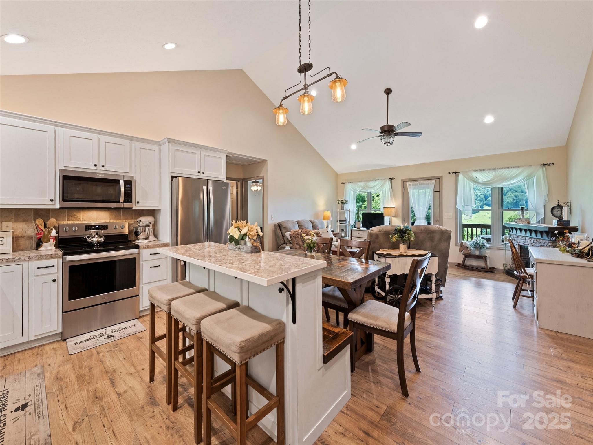 153 Trinity Drive Clyde, NC 28721 - Photo 17 of 38 a large kitchen with a table and chairs in it