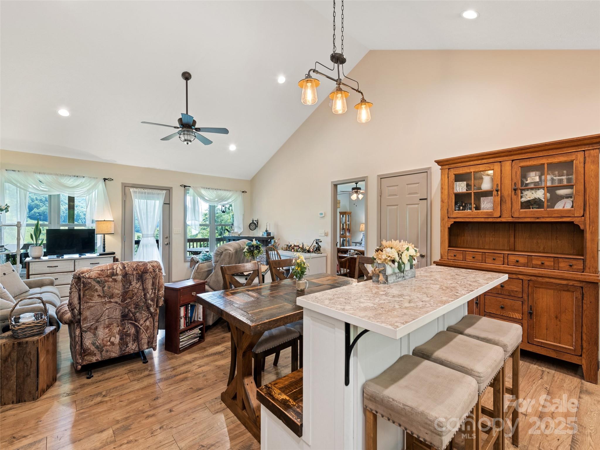 153 Trinity Drive Clyde, NC 28721 - Photo 20 of 38 a view of a dining room with furniture and wooden floor