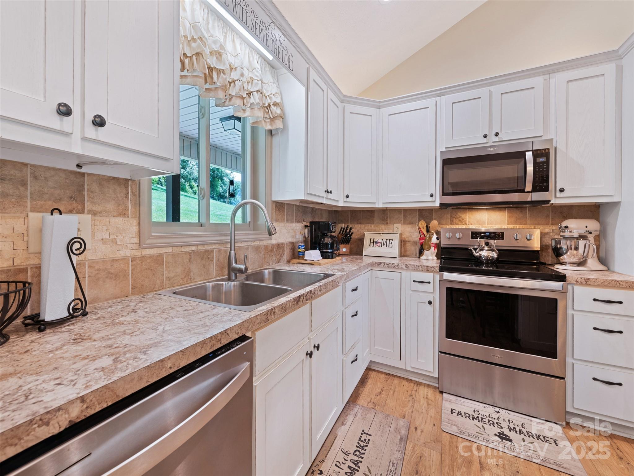 153 Trinity Drive Clyde, NC 28721 - Photo 21 of 38 a kitchen with granite countertop a sink a stove and cabinets