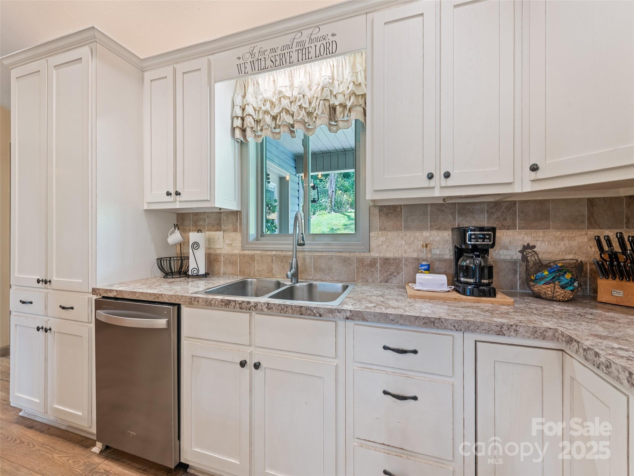 153 Trinity Drive Clyde, NC 28721 - Photo 22 of 38 a kitchen with granite countertop white cabinets and white appliances