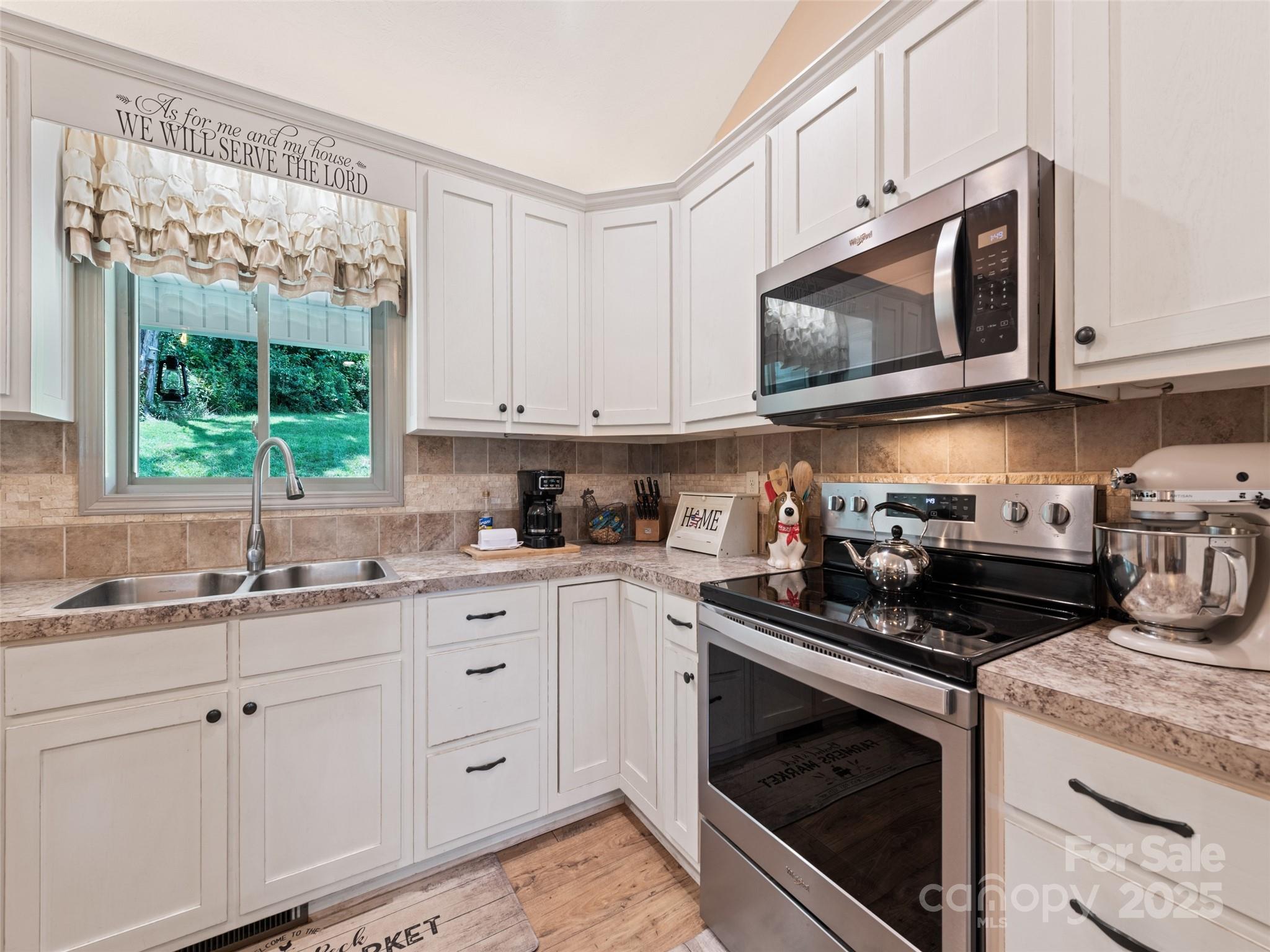 153 Trinity Drive Clyde, NC 28721 - Photo 23 of 38 a kitchen with cabinets appliances and a window
