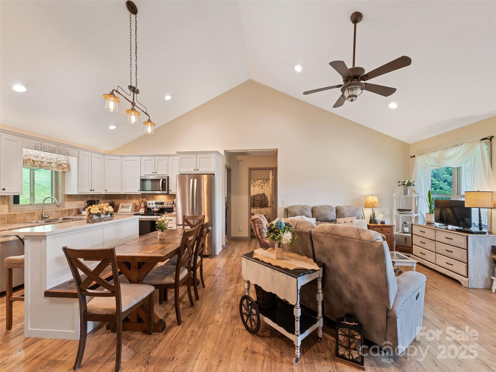 153 Trinity Drive Clyde, NC 28721 - Photo 25 of 38 a view of a dining room with furniture window and wooden floor