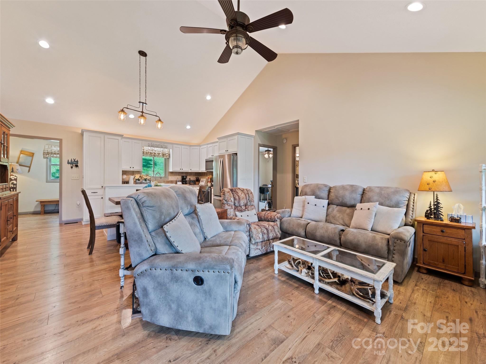 153 Trinity Drive Clyde, NC 28721 - Photo 26 of 38 a living room with furniture a ceiling fan and a rug