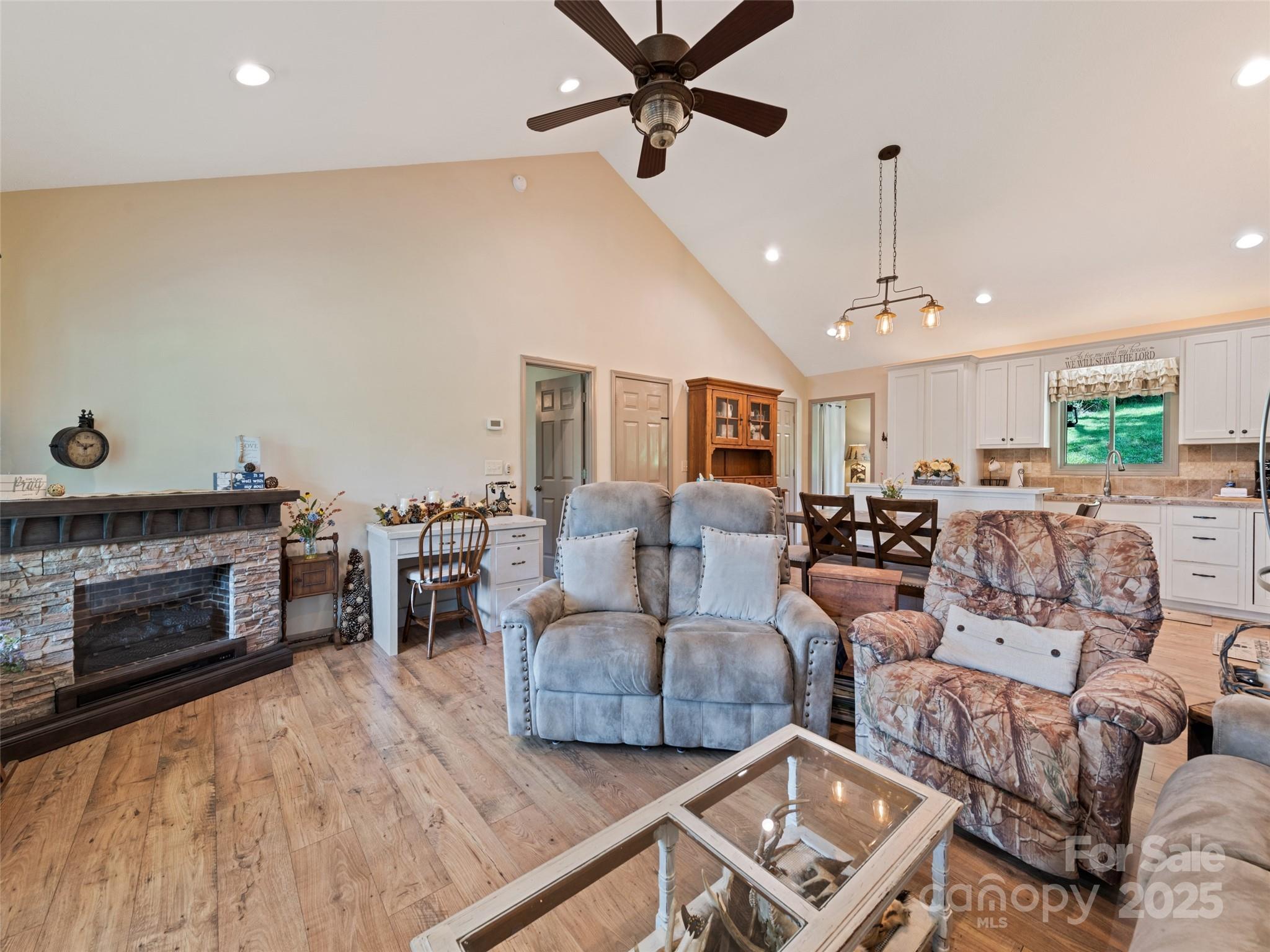 153 Trinity Drive Clyde, NC 28721 - Photo 27 of 38 a living room with furniture and a fireplace