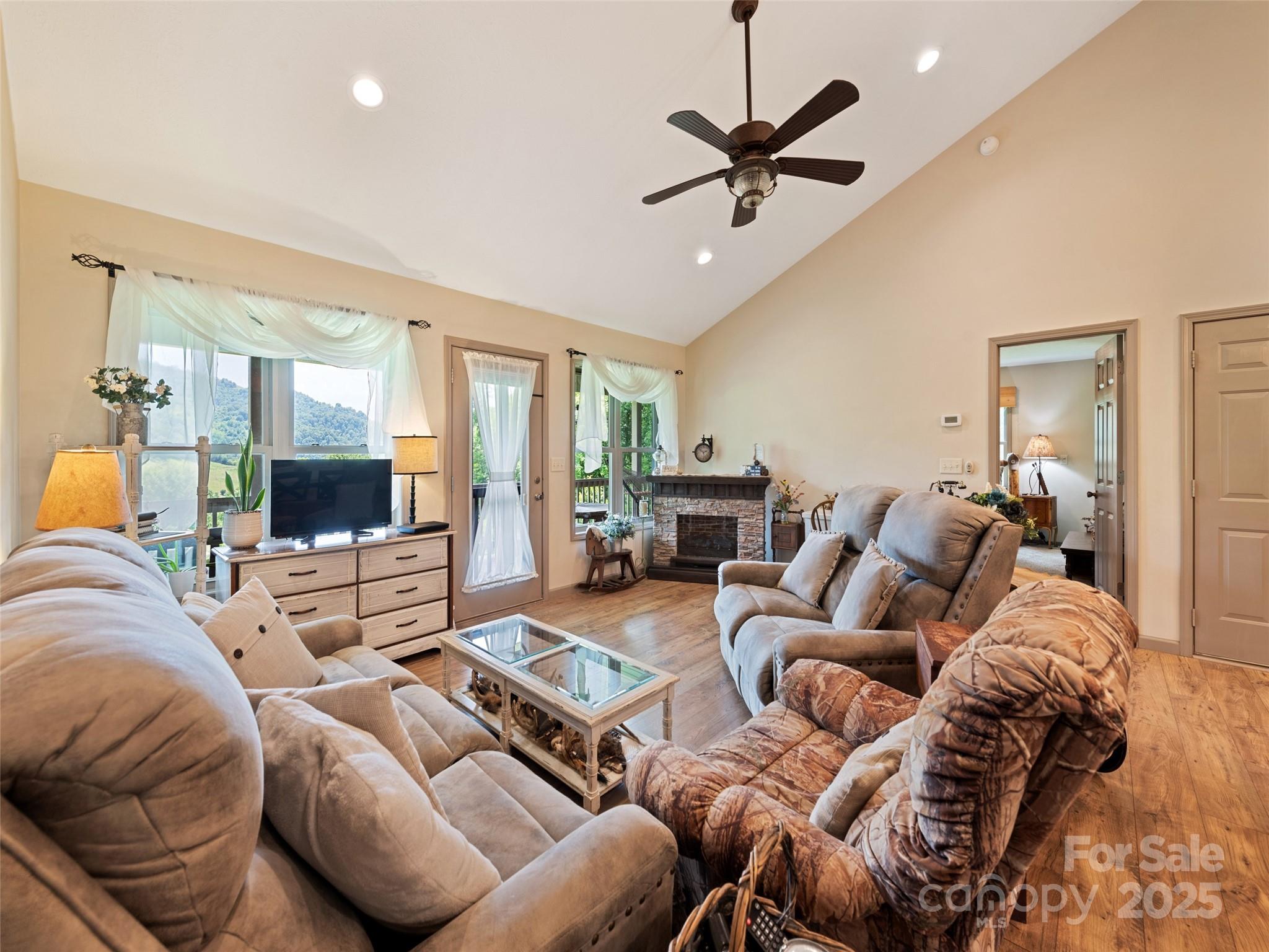 153 Trinity Drive Clyde, NC 28721 - Photo 28 of 38 a living room with furniture and a flat screen tv