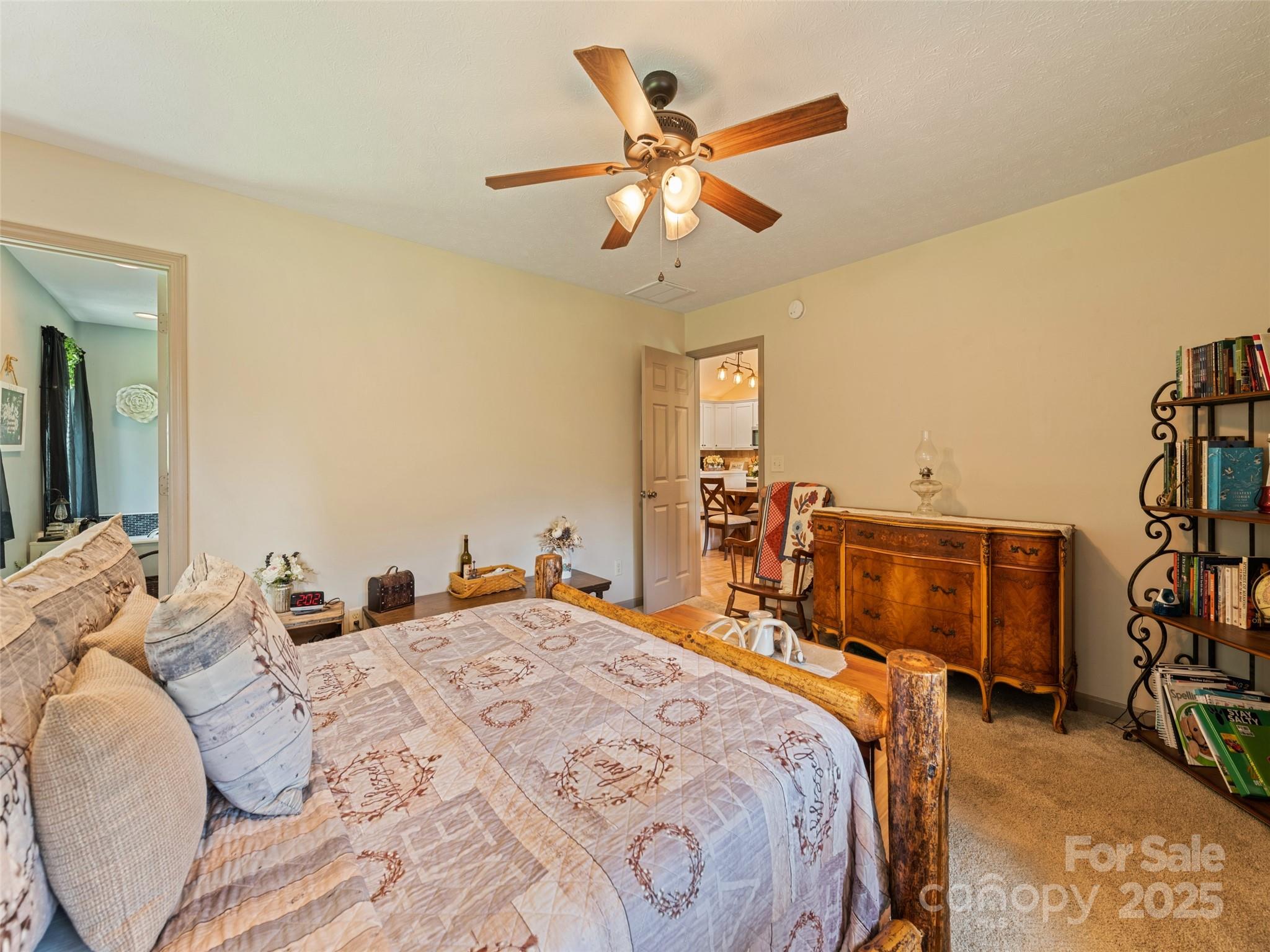 153 Trinity Drive Clyde, NC 28721 - Photo 30 of 38 a bedroom with a bed and a chandelier