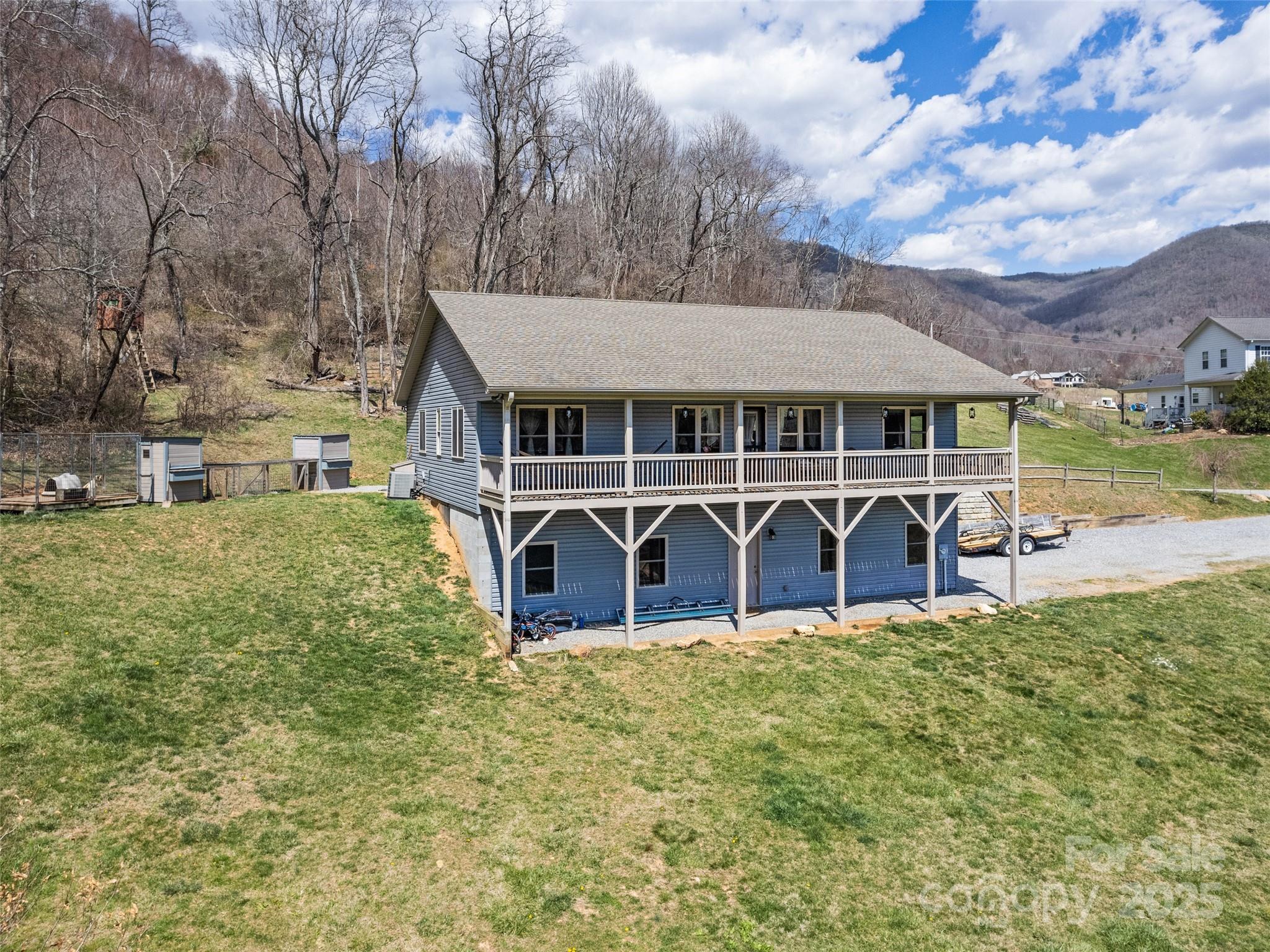 153 Trinity Drive Clyde, NC 28721 - Photo 3 of 38 a view of a house with pool and a yard