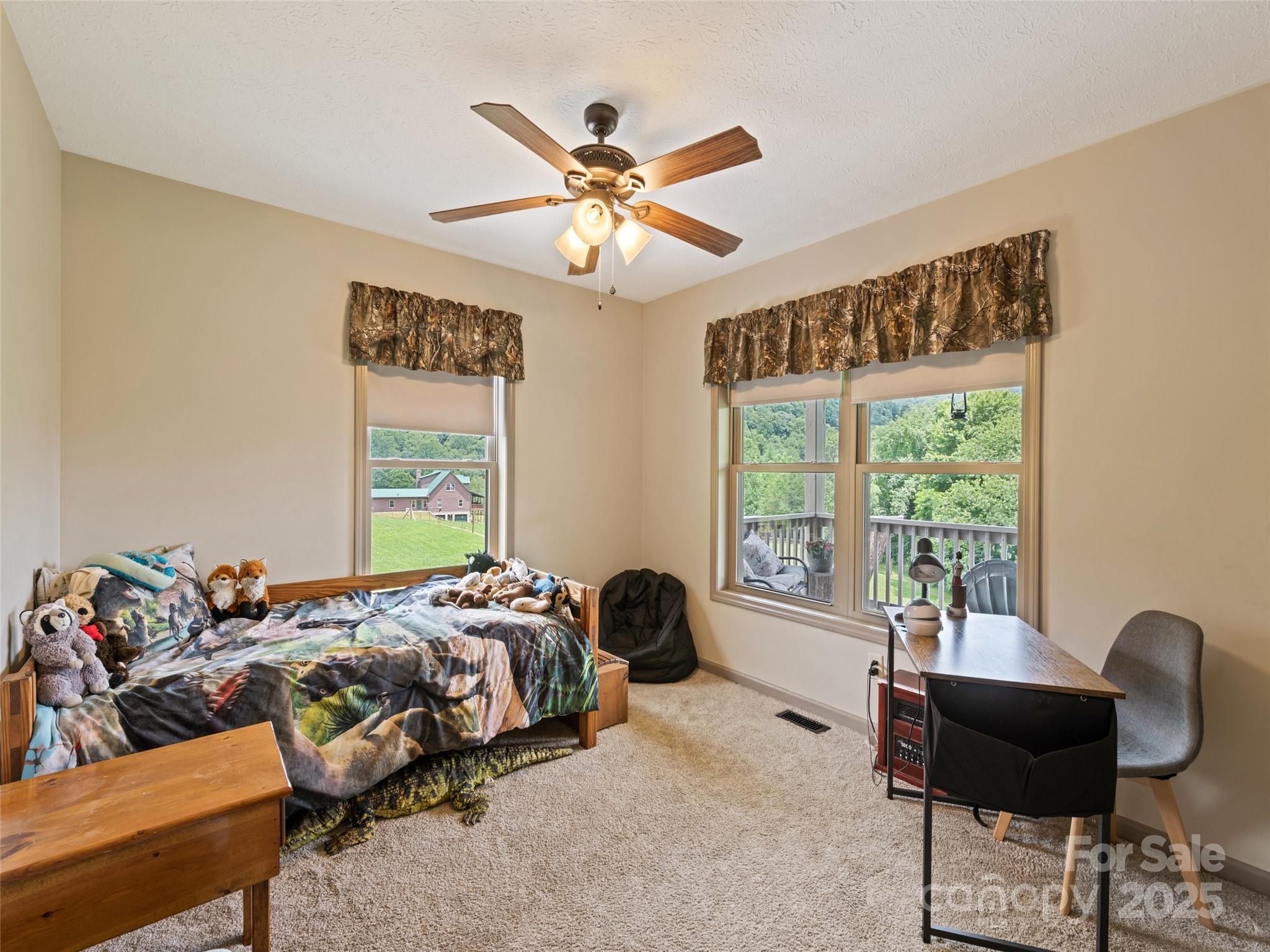 153 Trinity Drive Clyde, NC 28721 - Photo 32 of 38 a bedroom with a bed and a large window