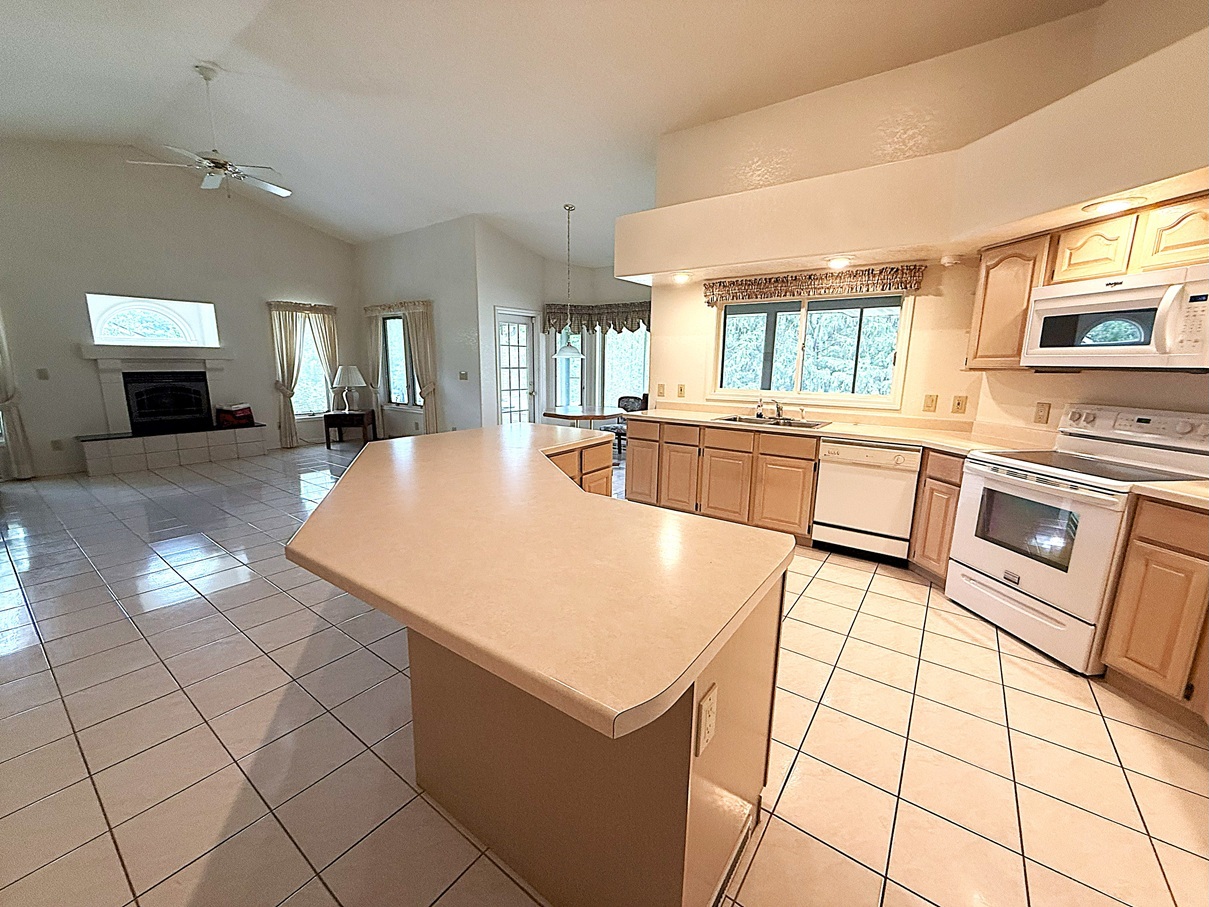 132 Fox Trot Dixon, IL 61021 - Photo 13 of 42 a large kitchen with kitchen island a stove a sink dishwasher and white cabinets with wooden floor