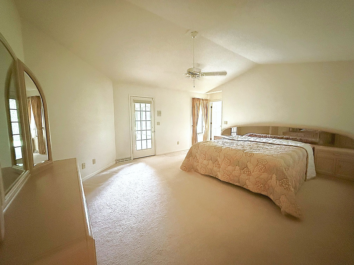132 Fox Trot Dixon, IL 61021 - Photo 19 of 42 a spacious bedroom with a bed and a chandelier