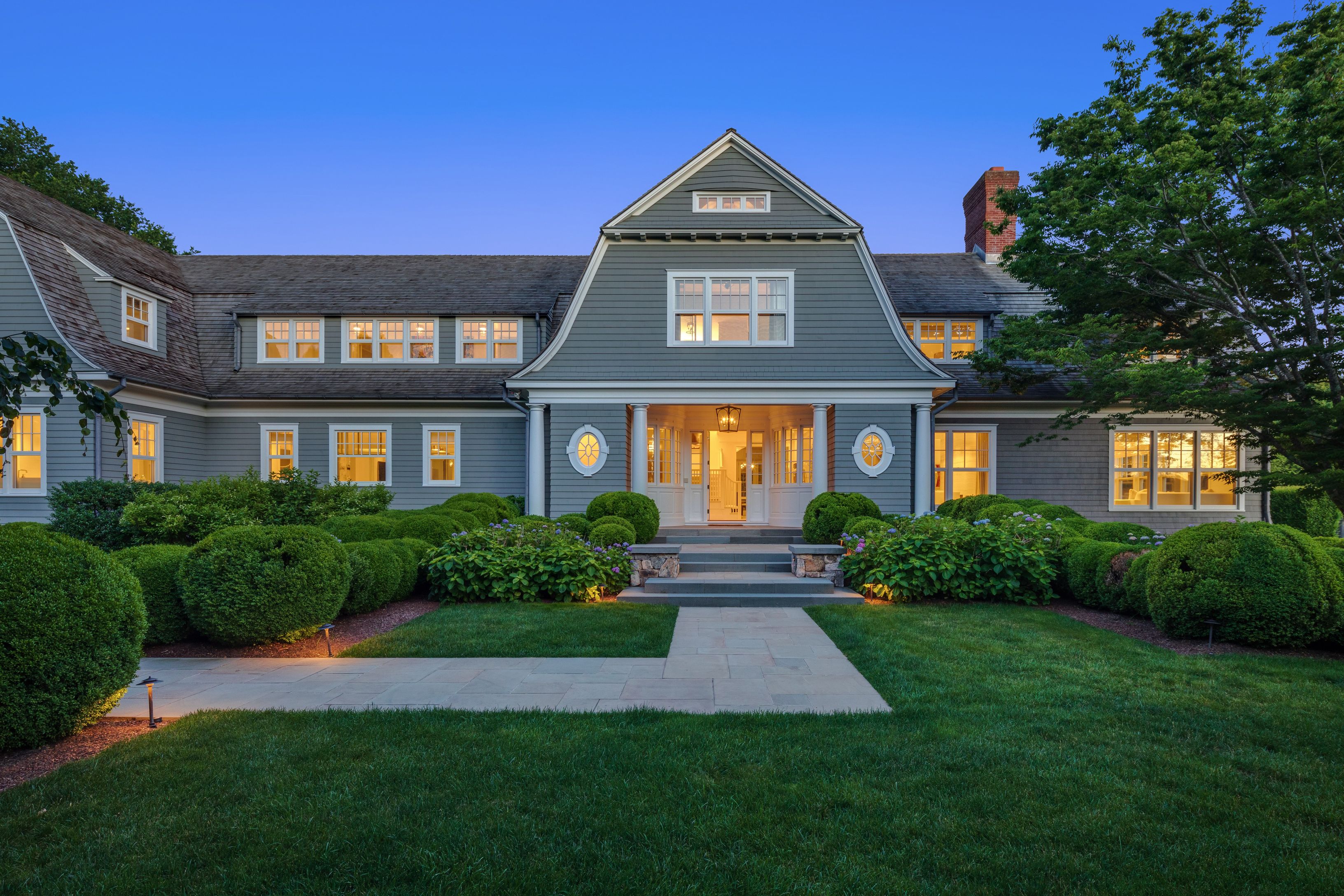 a front view of a brick house with a yard