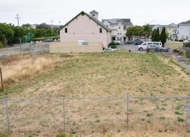 a view of a patio with table and chairs under an umbrella