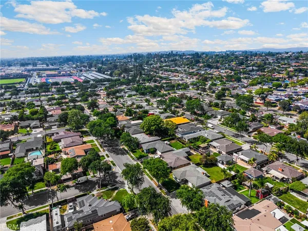 an aerial view of residential houses with city view