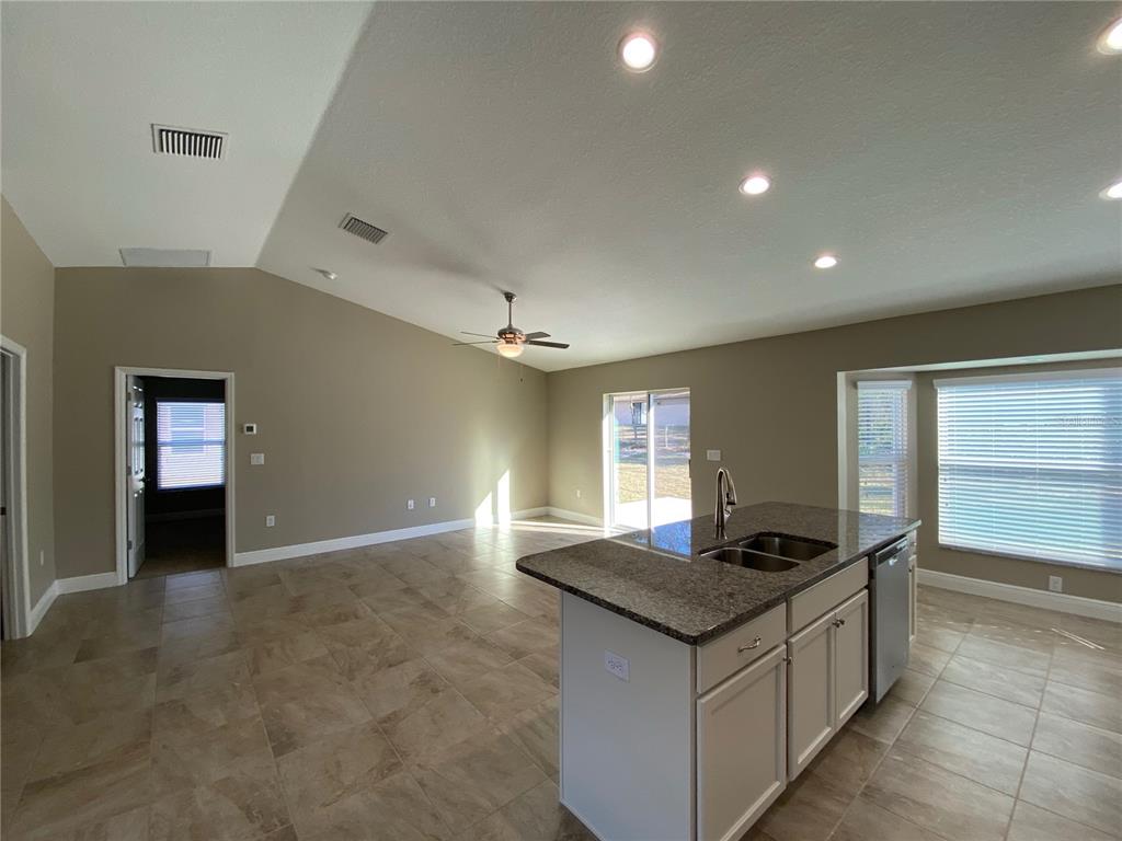4110 Southwest 132nd Lane Ocala, FL 34473 - Photo 13 of 30 a kitchen with granite countertop a sink and a stove