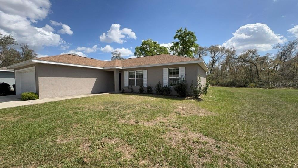 4110 Southwest 132nd Lane Ocala, FL 34473 - Photo 2 of 30 a view of a house with a backyard