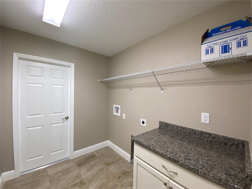 4110 Southwest 132nd Lane Ocala, FL 34473 - Photo 21 of 30 a view of a storage and utility room with a washer and dryer