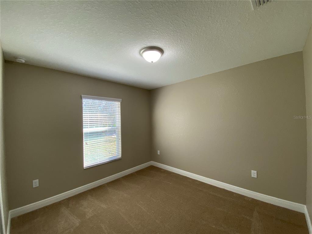 4110 Southwest 132nd Lane Ocala, FL 34473 - Photo 26 of 30 an empty room with a empty space and windows