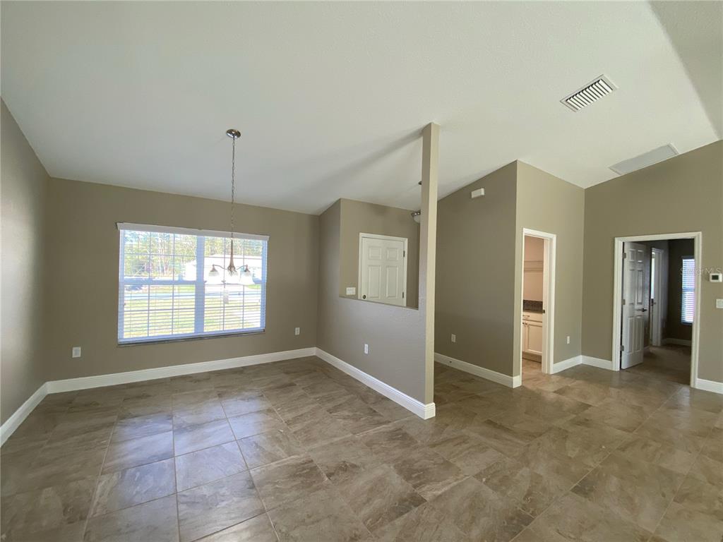 4110 Southwest 132nd Lane Ocala, FL 34473 - Photo 3 of 30 an empty room with windows and entrance