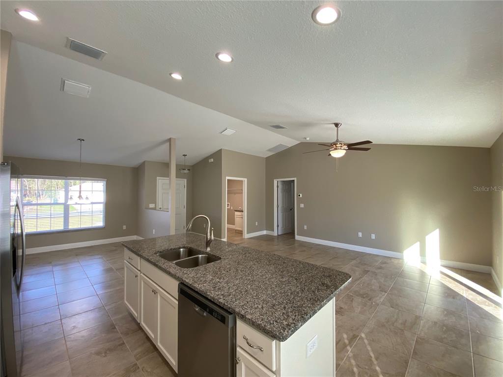 4110 Southwest 132nd Lane Ocala, FL 34473 - Photo 8 of 30 a kitchen with stainless steel appliances granite countertop a sink a stove and a granite counter tops