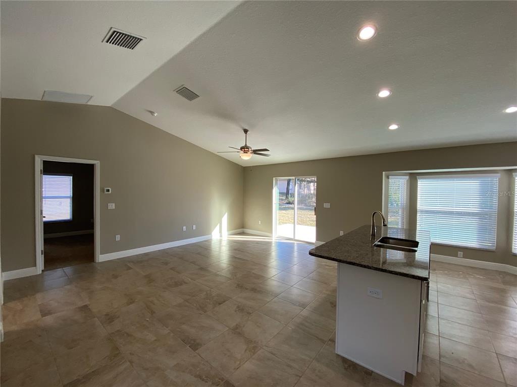 4110 Southwest 132nd Lane Ocala, FL 34473 - Photo 9 of 30 an empty room with kitchen and windows