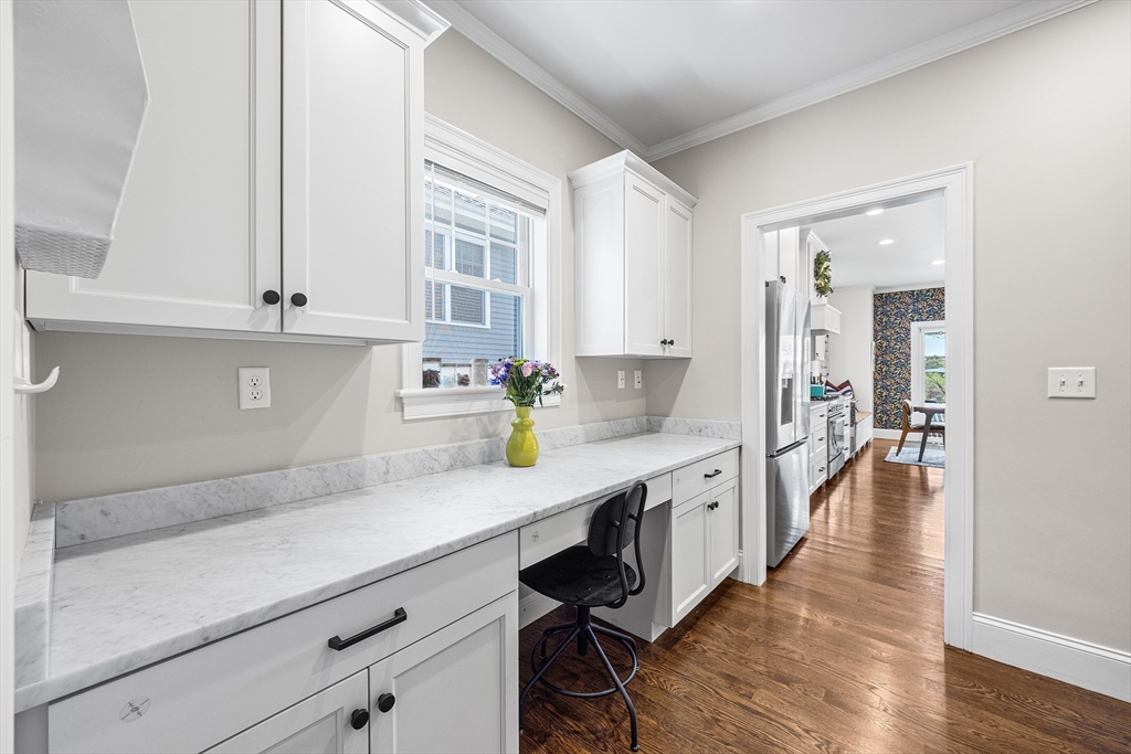 48 Hillcrest Road Waltham, MA 02451 - Photo 13 of 42 a hallway with white cabinets and wooden floor