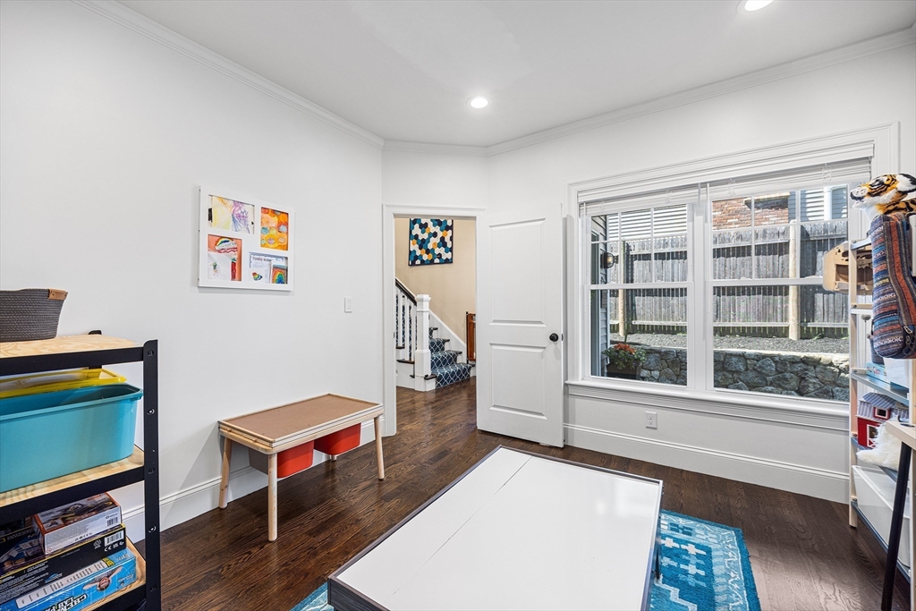 48 Hillcrest Road Waltham, MA 02451 - Photo 16 of 42 a living room with furniture a piano and a bookshelf