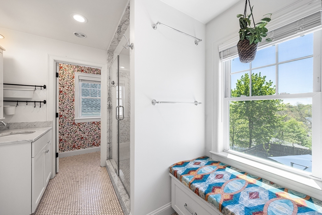 48 Hillcrest Road Waltham, MA 02451 - Photo 23 of 42 a bathroom with a sink a large mirror and a shower