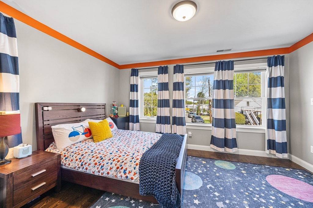 48 Hillcrest Road Waltham, MA 02451 - Photo 24 of 42 a bedroom with a bed and wooden floor