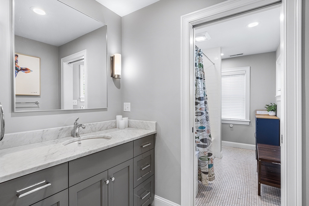 48 Hillcrest Road Waltham, MA 02451 - Photo 26 of 42 a bathroom with a sink a vanity and a mirror