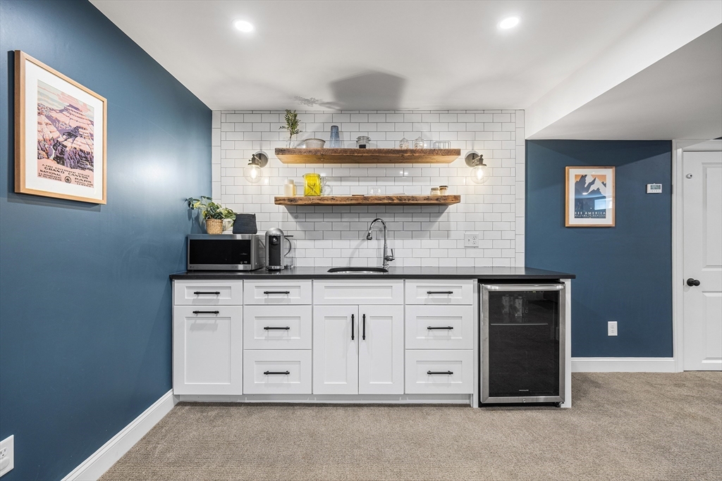 48 Hillcrest Road Waltham, MA 02451 - Photo 31 of 42 a kitchen with stainless steel appliances granite countertop a stove a sink and a refrigerator