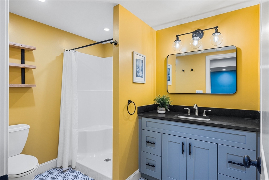 48 Hillcrest Road Waltham, MA 02451 - Photo 35 of 42 a bathroom with a granite countertop sink mirror and a toilet