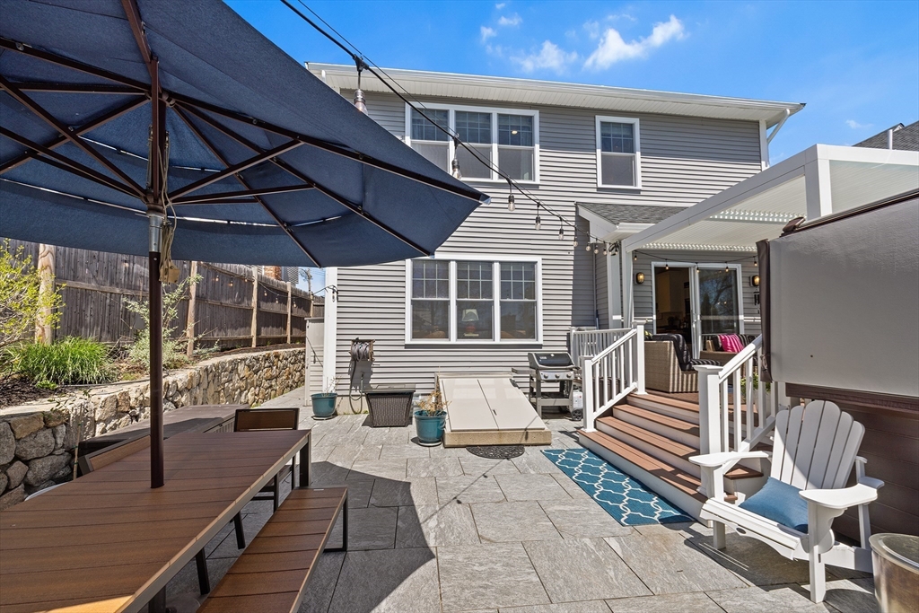 48 Hillcrest Road Waltham, MA 02451 - Photo 36 of 42 a view of a patio with a table and chairs