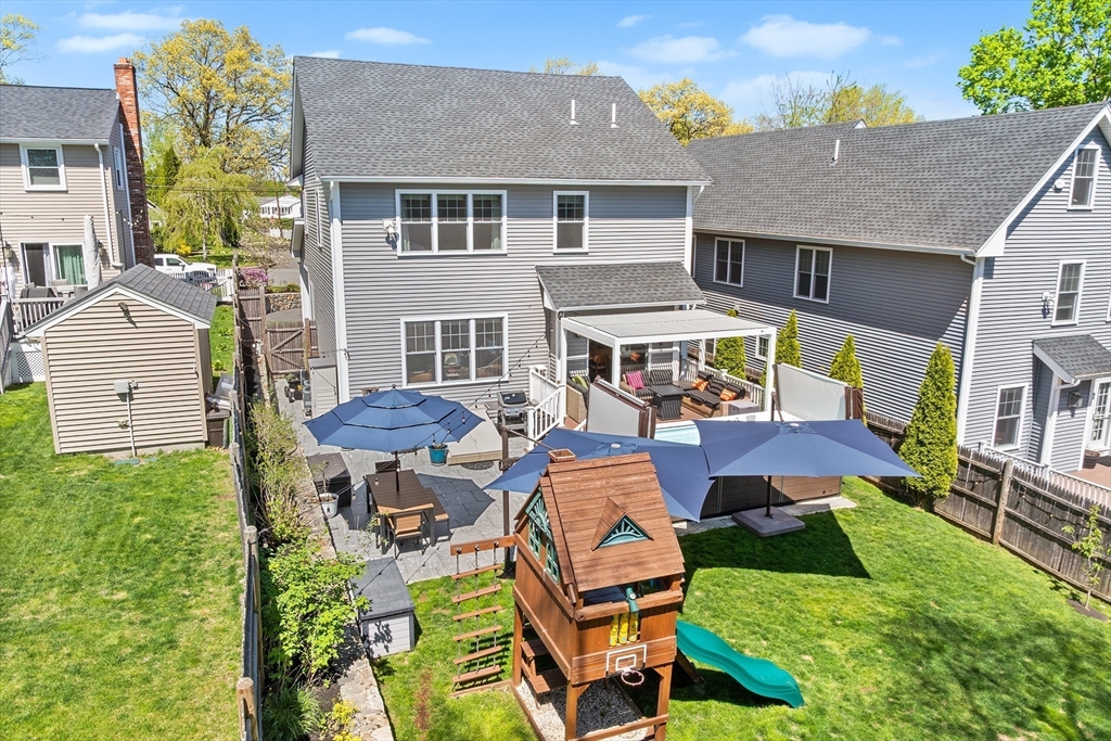 48 Hillcrest Road Waltham, MA 02451 - Photo 38 of 42 a aerial view of a house with swimming pool table and chairs
