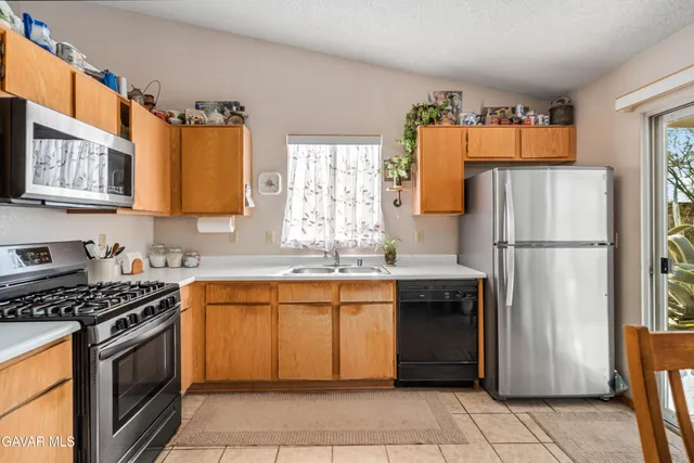 a kitchen with stainless steel appliances granite countertop a refrigerator stove a sink and dishwasher