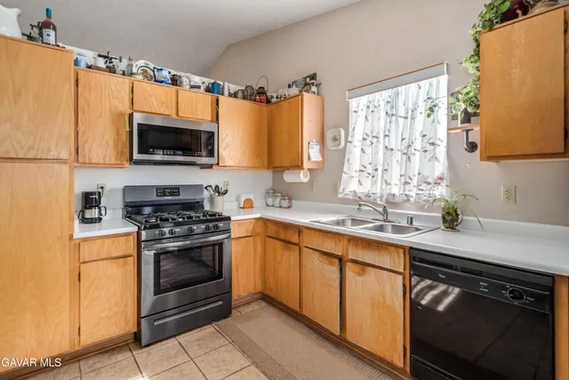a kitchen with stainless steel appliances a stove sink and microwave