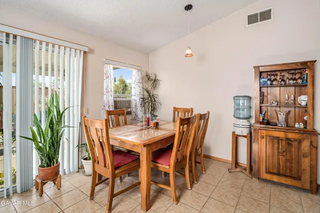 a dining room with furniture and window