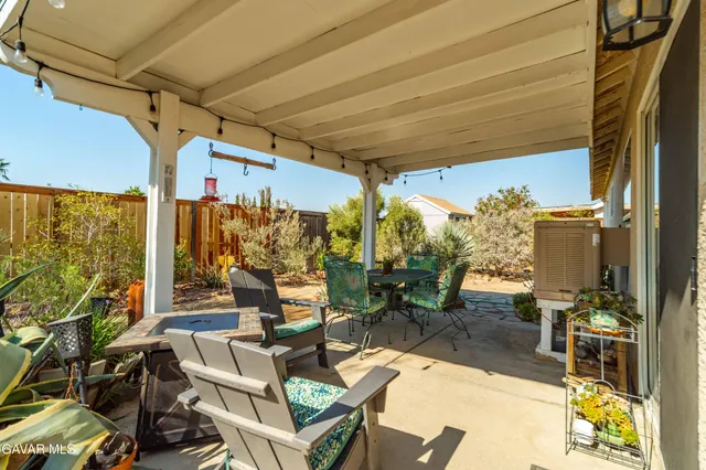 a view of living room with patio furniture and floor to ceiling windows