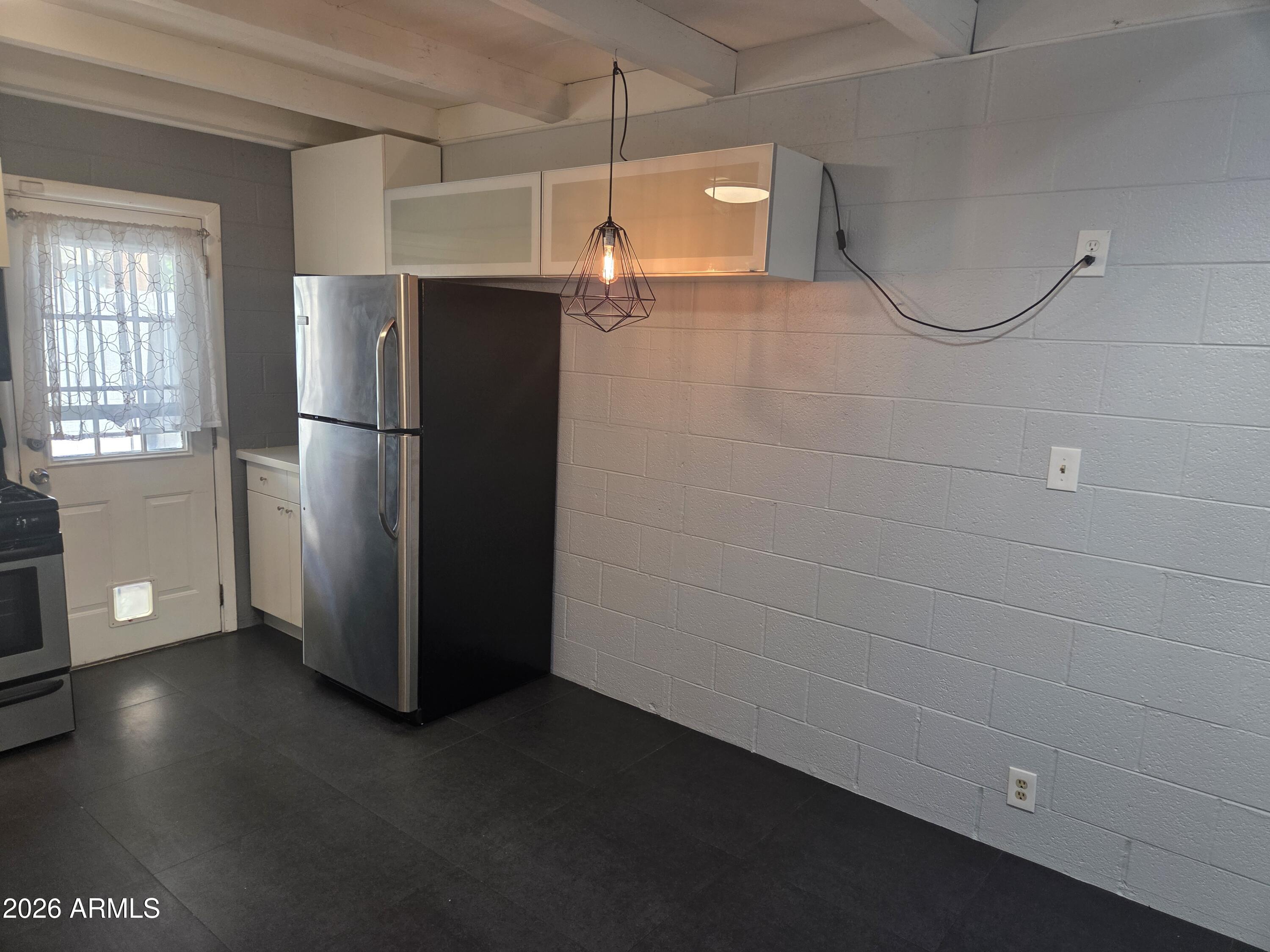 1101 East Bethany Home Road, Unit 7 Phoenix, AZ 85014 - Photo 7 of 14 a view of a refrigerator in kitchen and dishwasher