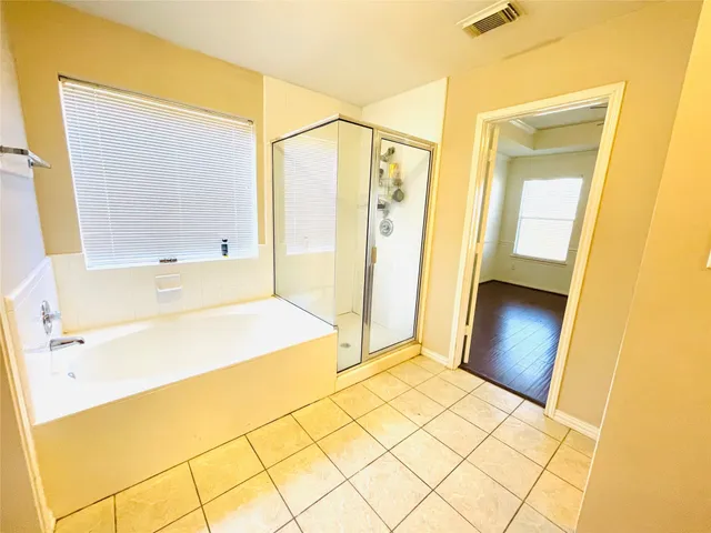 a bathroom with a bathtub and shower