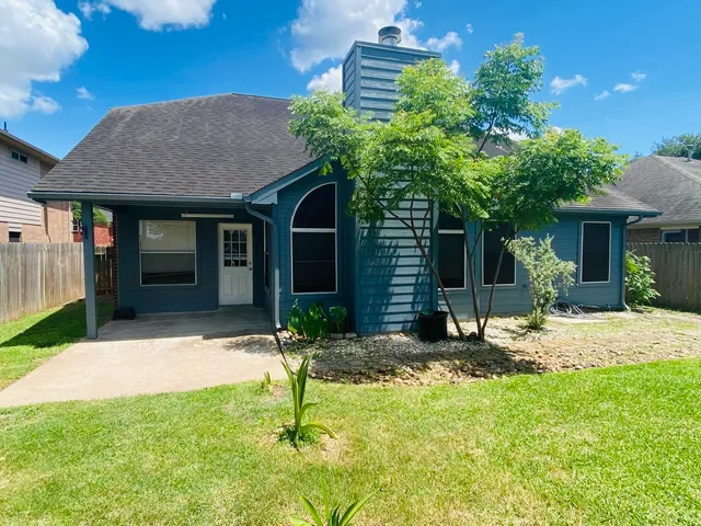 a view of a brick house with many windows
