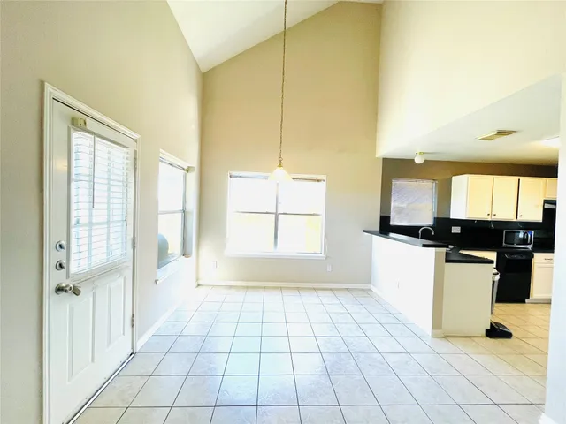 a view of a kitchen with kitchen island and windows