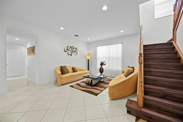 a living room with furniture and kitchen view