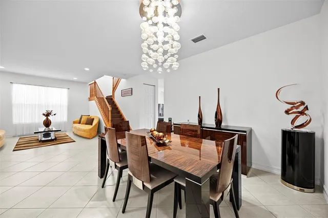 a kitchen with stainless steel appliances granite countertop a sink dishwasher stove refrigerator and cabinets