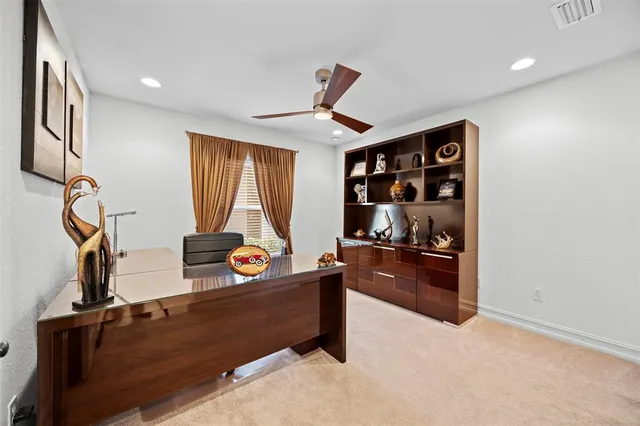 a kitchen with granite countertop wooden cabinets stainless steel appliances a stove a sink and a refrigerator