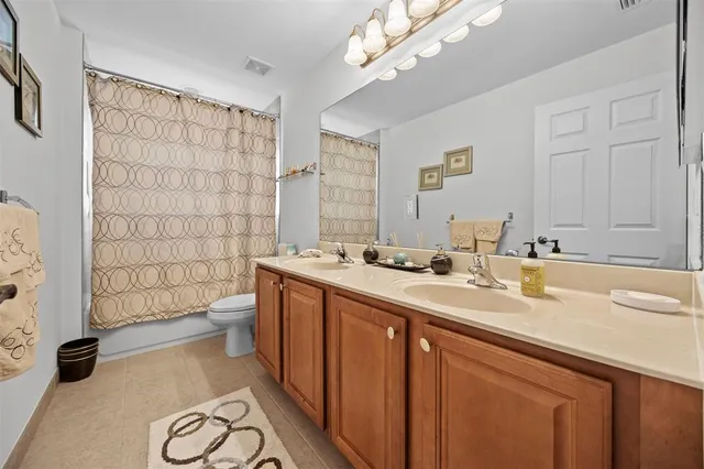 an aerial view of a houses with a yard and lake view