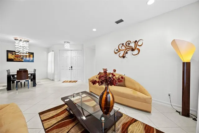 a living room with furniture and a gym equipment