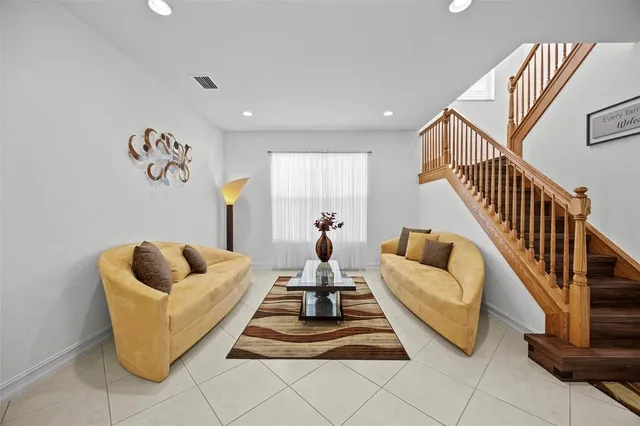 a living room with furniture and stairs