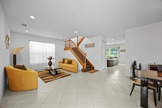 a living room with furniture and kitchen view
